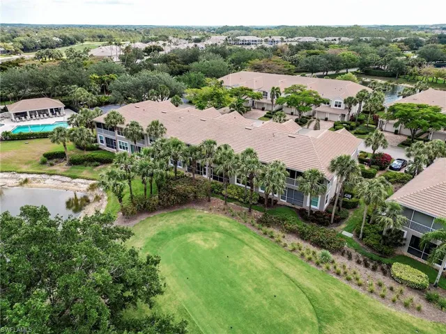 Aerial view of residential area featuring a large body of water and a golf course
