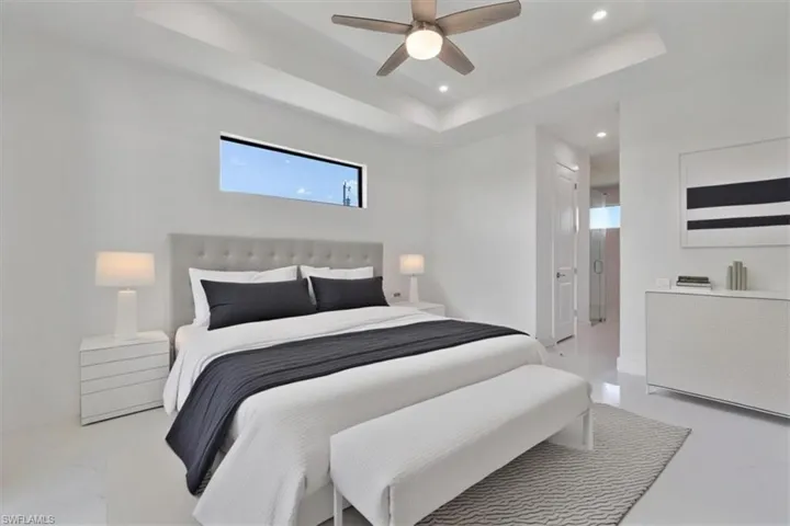 Bedroom featuring recessed lighting, a ceiling fan, and a raised ceiling