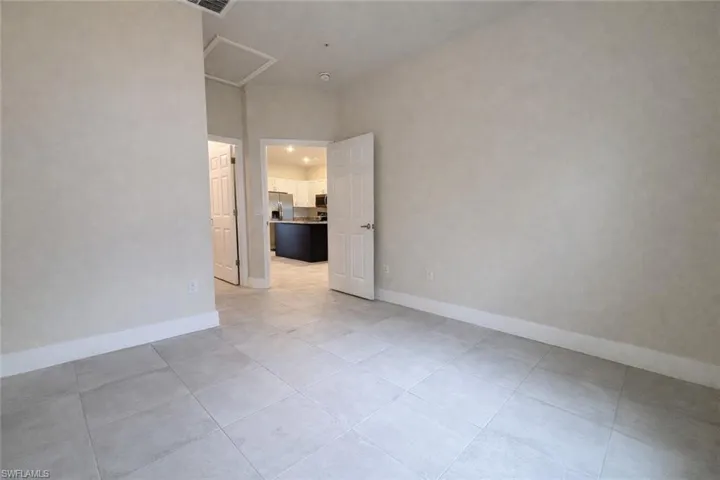 Empty room featuring baseboards and light tile patterned floors