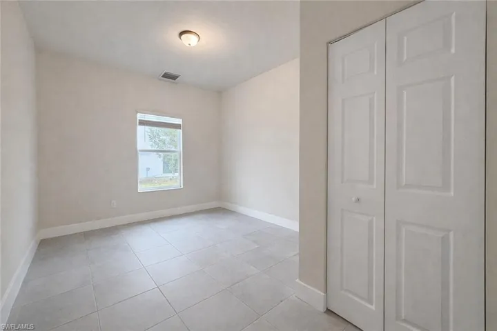 Unfurnished room featuring baseboards and light tile patterned floors