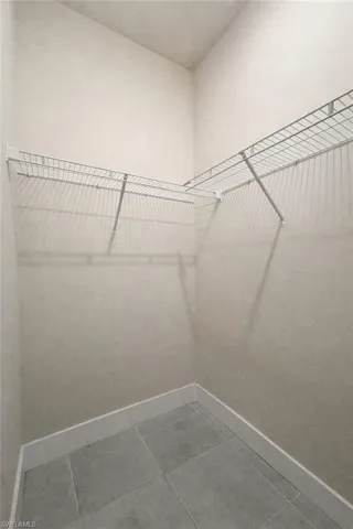 Walk in closet with tile patterned flooring