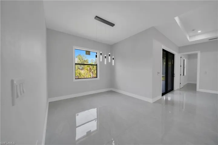 Empty room with baseboards, recessed lighting, and tile patterned flooring