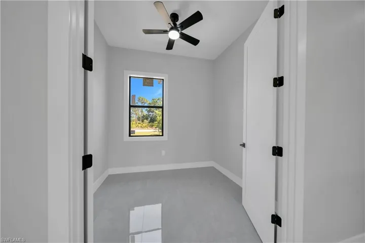 Spare room with baseboards and ceiling fan