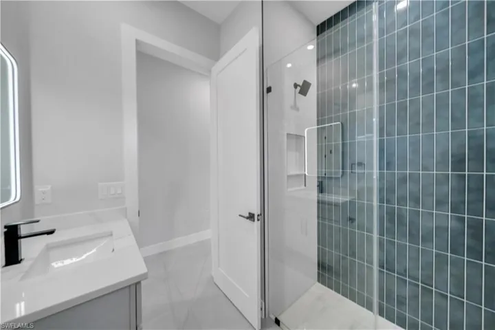 Bathroom featuring walk in shower and vanity