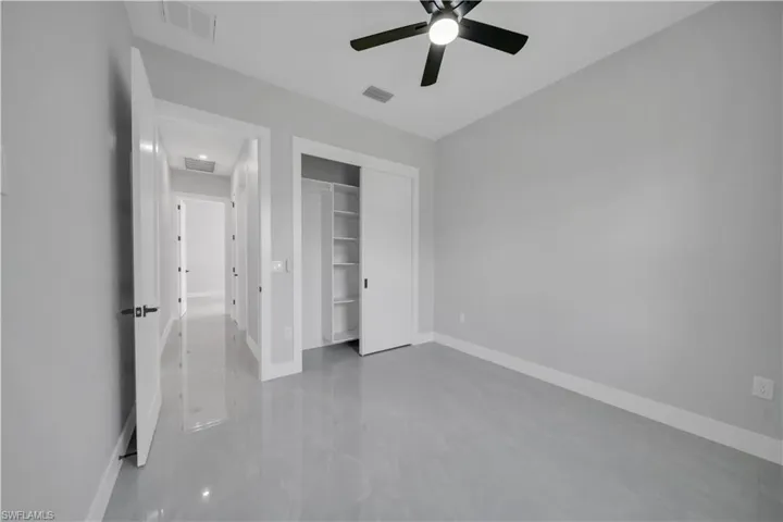Unfurnished bedroom with baseboards, a closet, and a ceiling fan