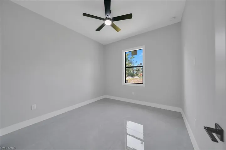Spare room featuring baseboards and ceiling fan