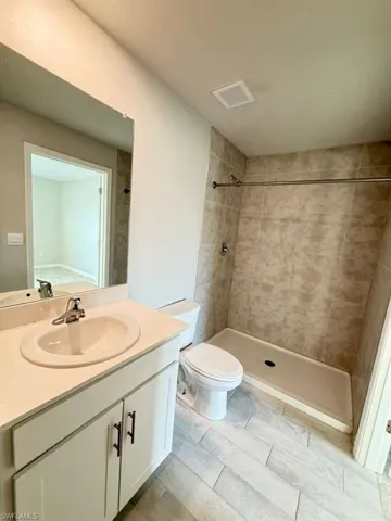 Bathroom featuring vanity and a shower stall