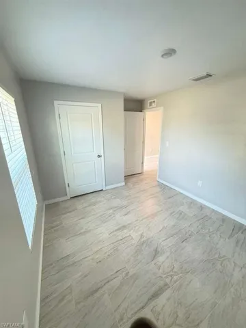Unfurnished bedroom featuring baseboards