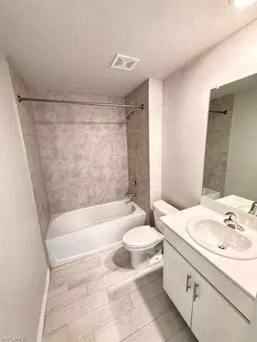 Bathroom with shower / washtub combination and vanity