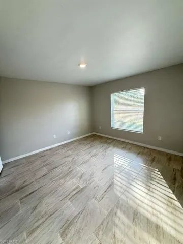 Unfurnished room with baseboards