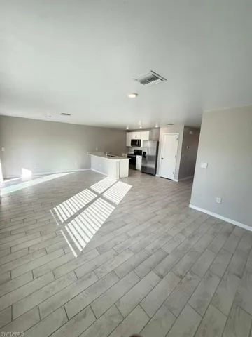 Unfurnished living room with baseboards