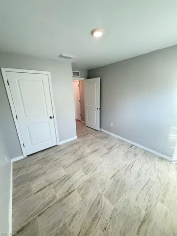 Unfurnished bedroom featuring baseboards and a closet