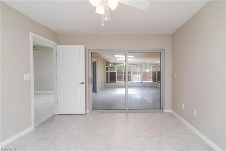 Unfurnished room featuring a ceiling fan and baseboards