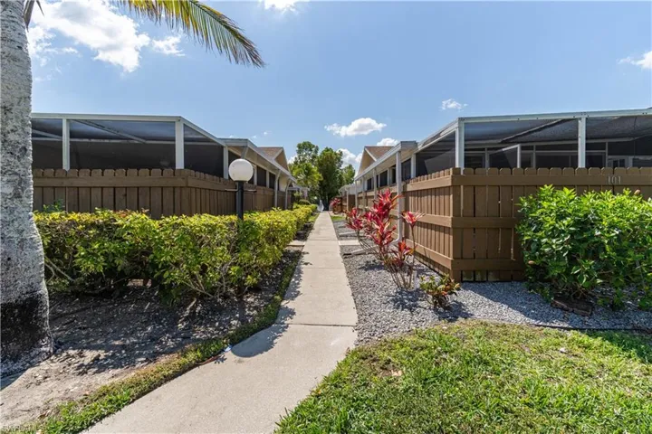 View of home's community with fence