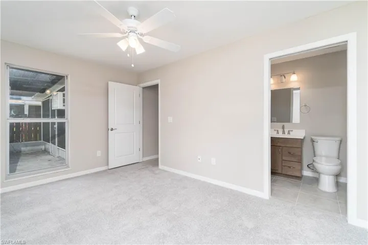 Unfurnished bedroom featuring baseboards, carpet flooring, and a sink