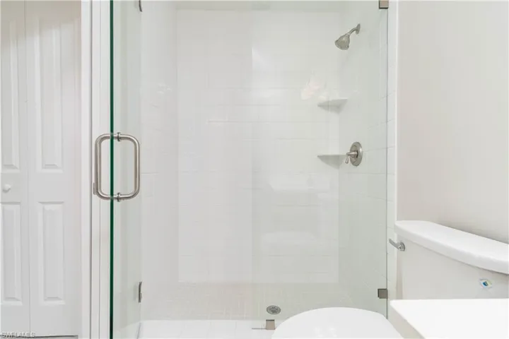 Full bath with a stall shower and toilet