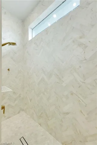 Bathroom featuring a marble finish shower