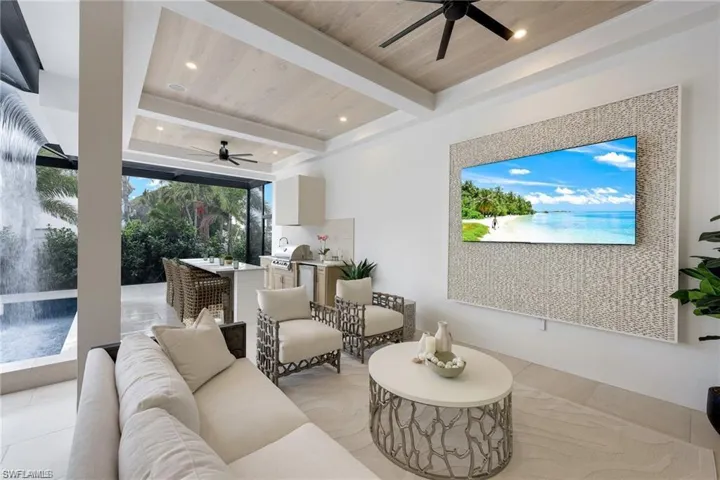 Living area featuring a ceiling fan, a wood ceiling with exposed beams, and recessed lighting