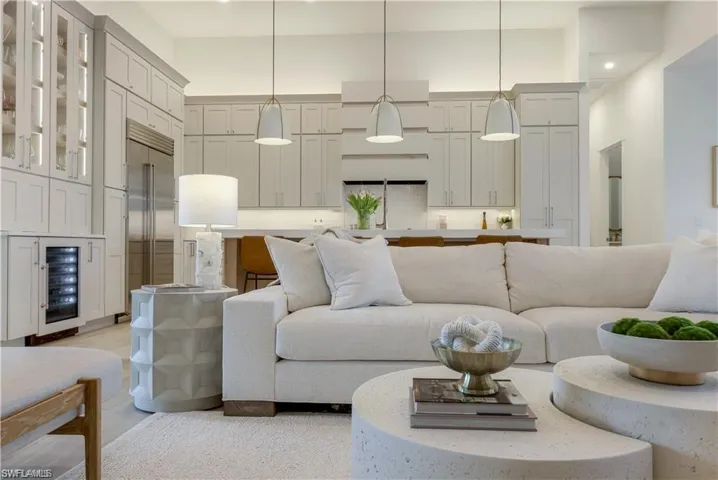 Living area with beverage cooler and a high ceiling