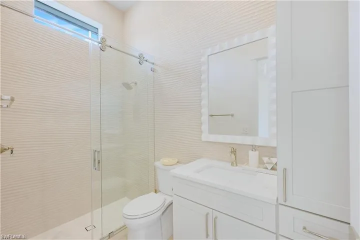 Full bathroom featuring vanity and a stall shower