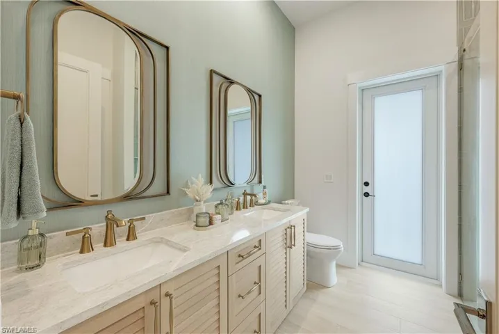 Bathroom with double vanity and toilet