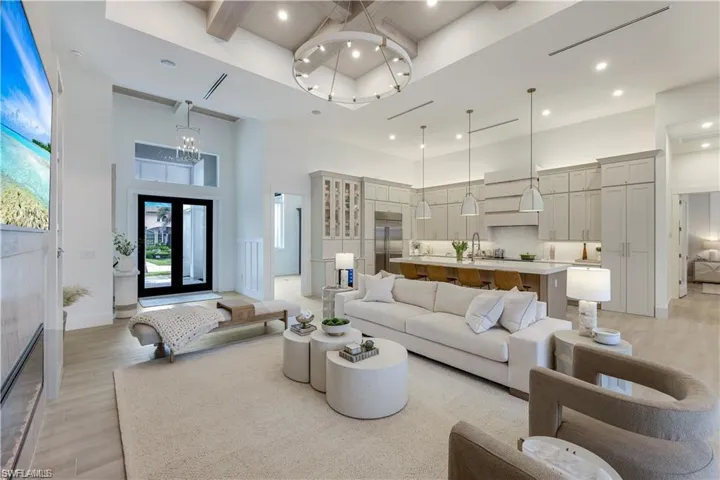 Living room with light wood finished floors and recessed lighting