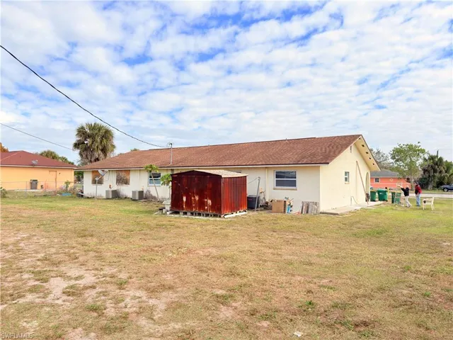 Rear view of house featuring a shed