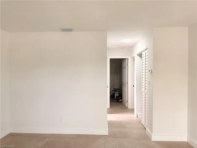 Empty room featuring baseboards