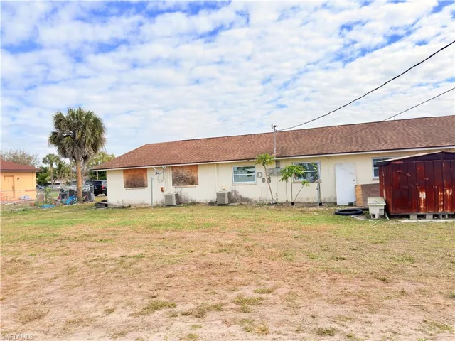 Back of house with a shed