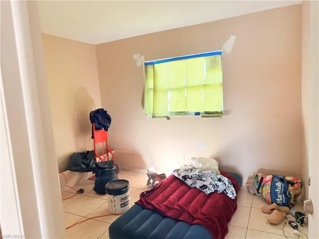 Unfurnished bedroom featuring tile patterned flooring