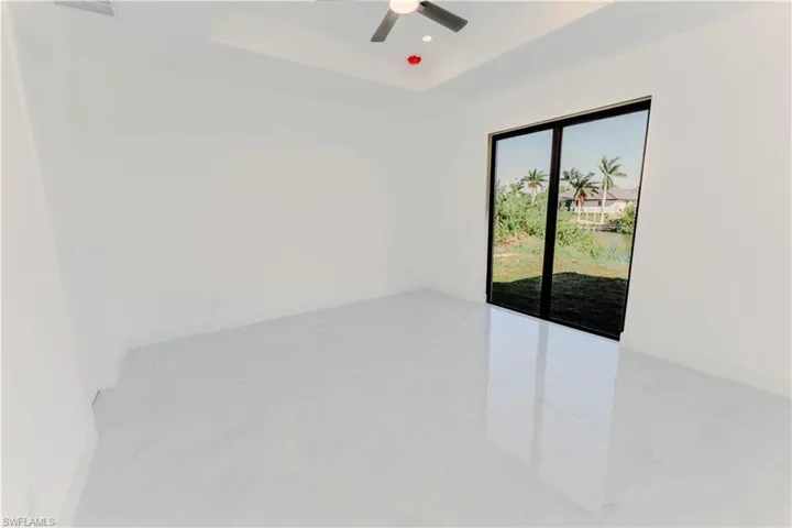 Spare room with recessed lighting, baseboards, a raised ceiling, and a ceiling fan