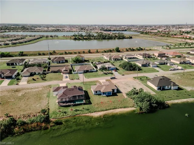 Drone / aerial view featuring a residential view and a water view
