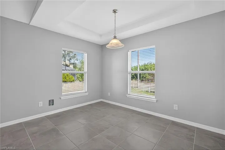 Dining room with a raised ceiling and plenty of natural light