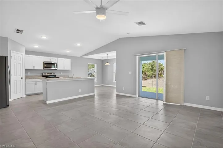 The Great Room featuring a ceiling fan, healthy amount of natural light, tile patterned floors, and recessed lighting