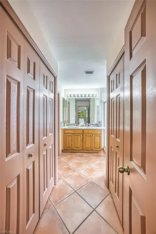 Bathroom featuring light tile patterned floors and double vanity
