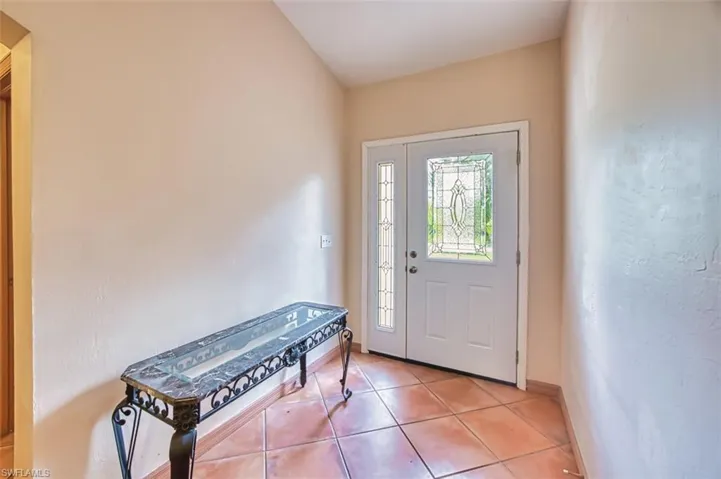 Foyer featuring tile patterned flooring and baseboards