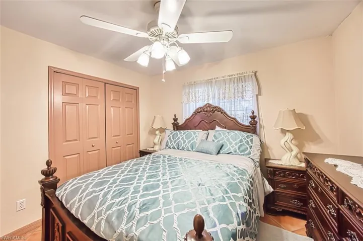 Bedroom featuring a ceiling fan and a closet
