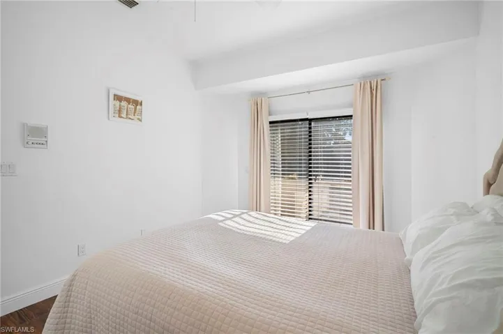 Bedroom featuring wood finished floors and baseboards