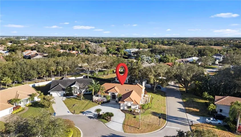 Aerial view of property and surrounding area with nearby suburban area
