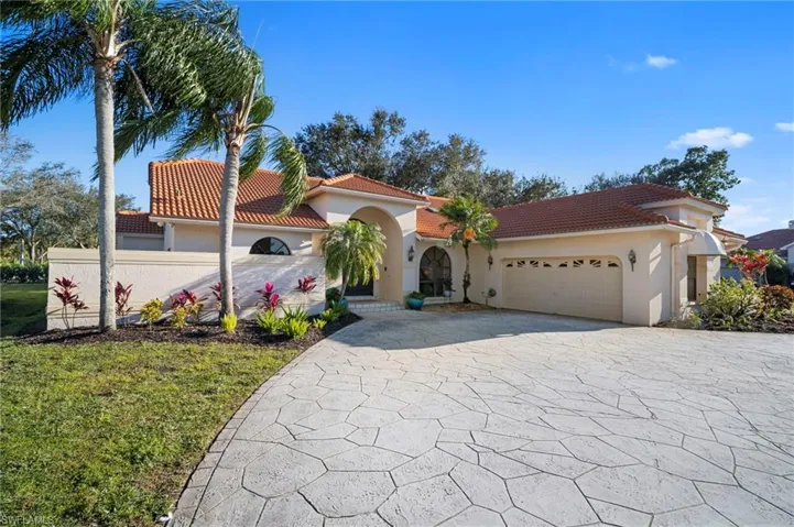 Mediterranean / spanish-style house featuring driveway, a tiled roof, stucco siding, and an attached garage