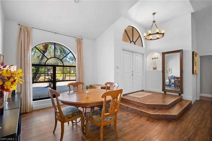 Dining area featuring hanging lights, hardwood / wood-style floors, and lofted ceiling
