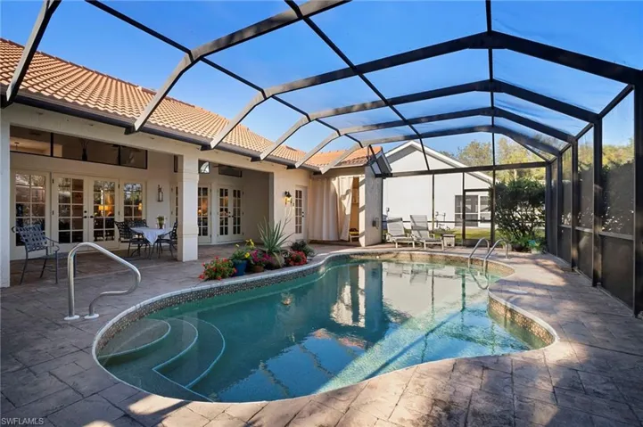 Outdoor pool with french doors, glass enclosure, a sunroom, a patio area, and outdoor dining area