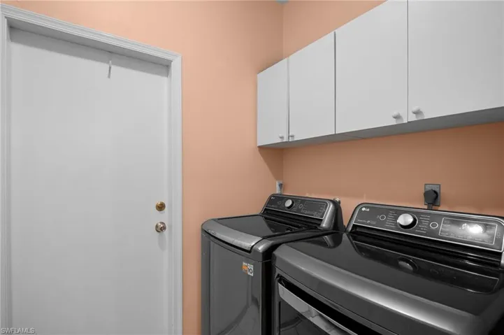 Laundry room featuring cabinet space and washing machine and dryer