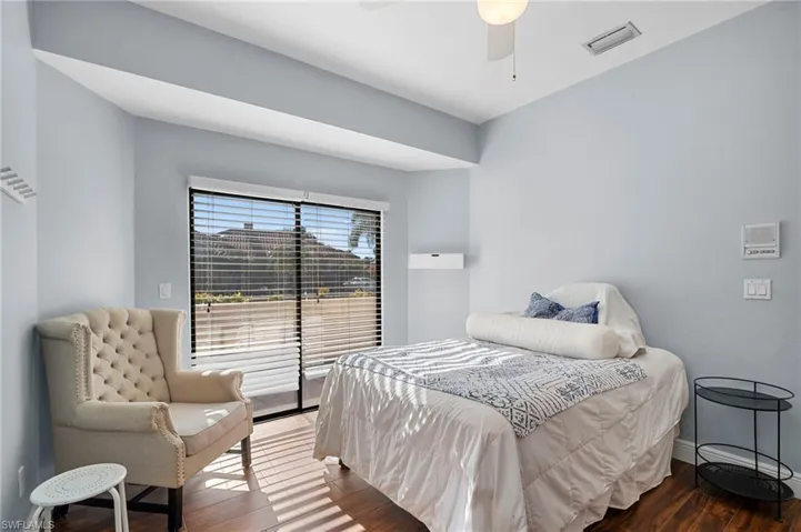 Bedroom with hardwood / wood-style flooring and ceiling fan