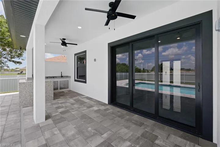 View of patio / terrace featuring ceiling fan, a fenced in pool, and french doors