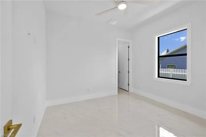 Unfurnished room featuring ceiling fan and light tile patterned floors