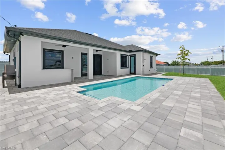 View of swimming pool featuring a patio and ceiling fan