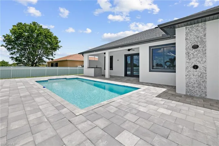 View of pool with ceiling fan and a patio area