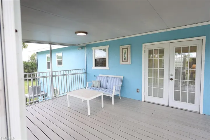 Wooden terrace featuring french doors
