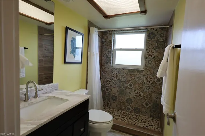 Bathroom featuring vanity and a stall shower